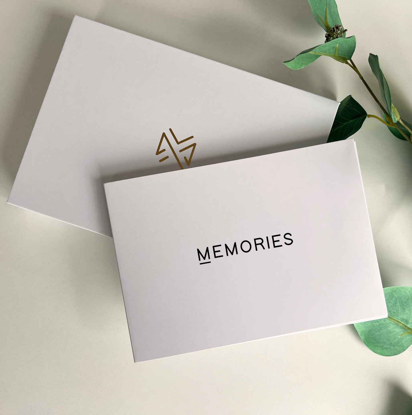 Memory Vault video book on the table with the box it comes in which has Memory Vault logo on it. This video book has Memories written on it black colour