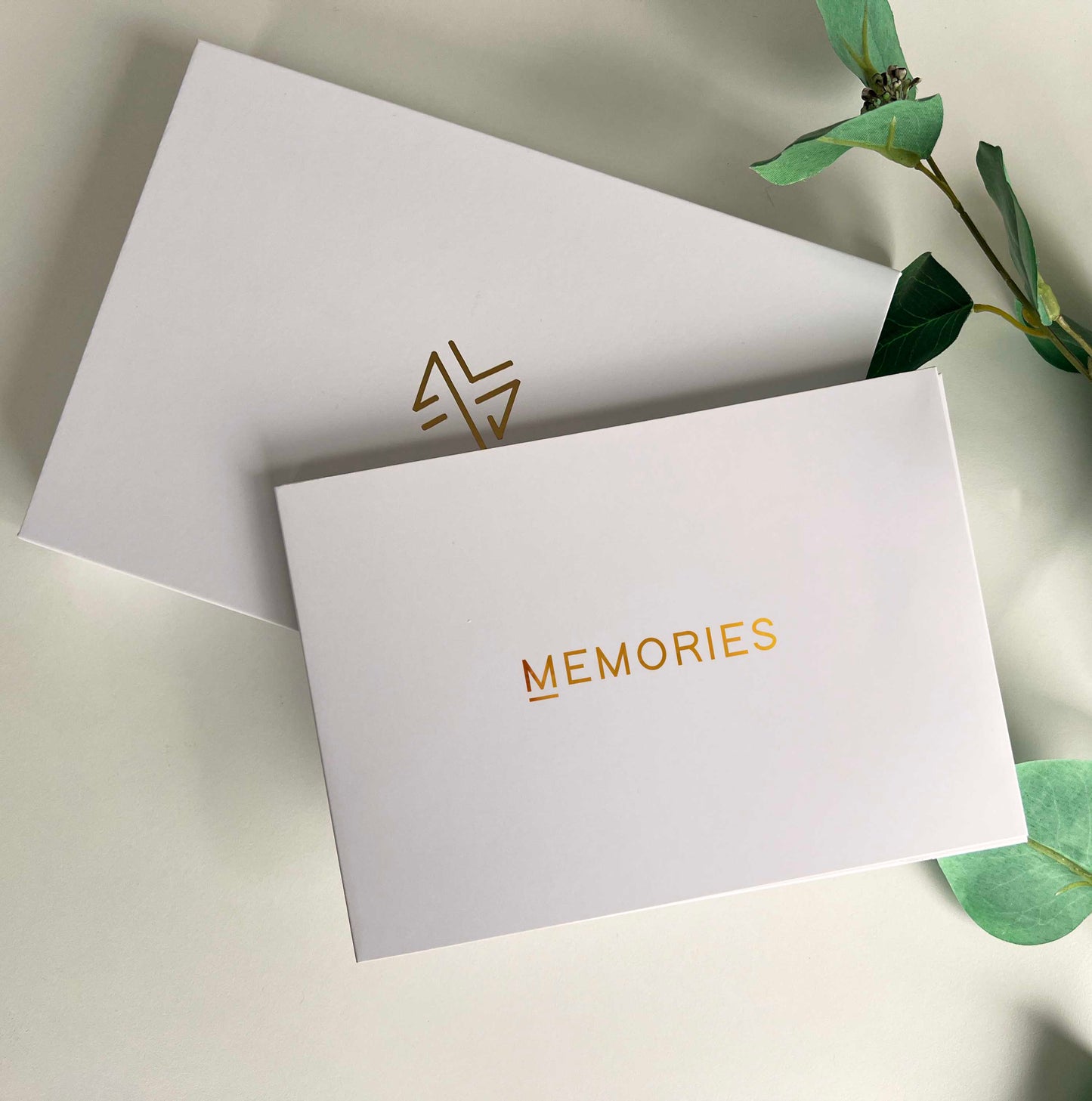Memory Vault video book on the table with the box it comes in which has Memory Vault logo on it. This video book has Happy Birthday written on it gold colour