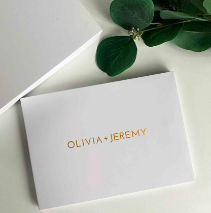Memory Vault video book on the table with the box it comes in which has Memory Vault logo on it. This video book is personalised with custom name written on it in gold colour
