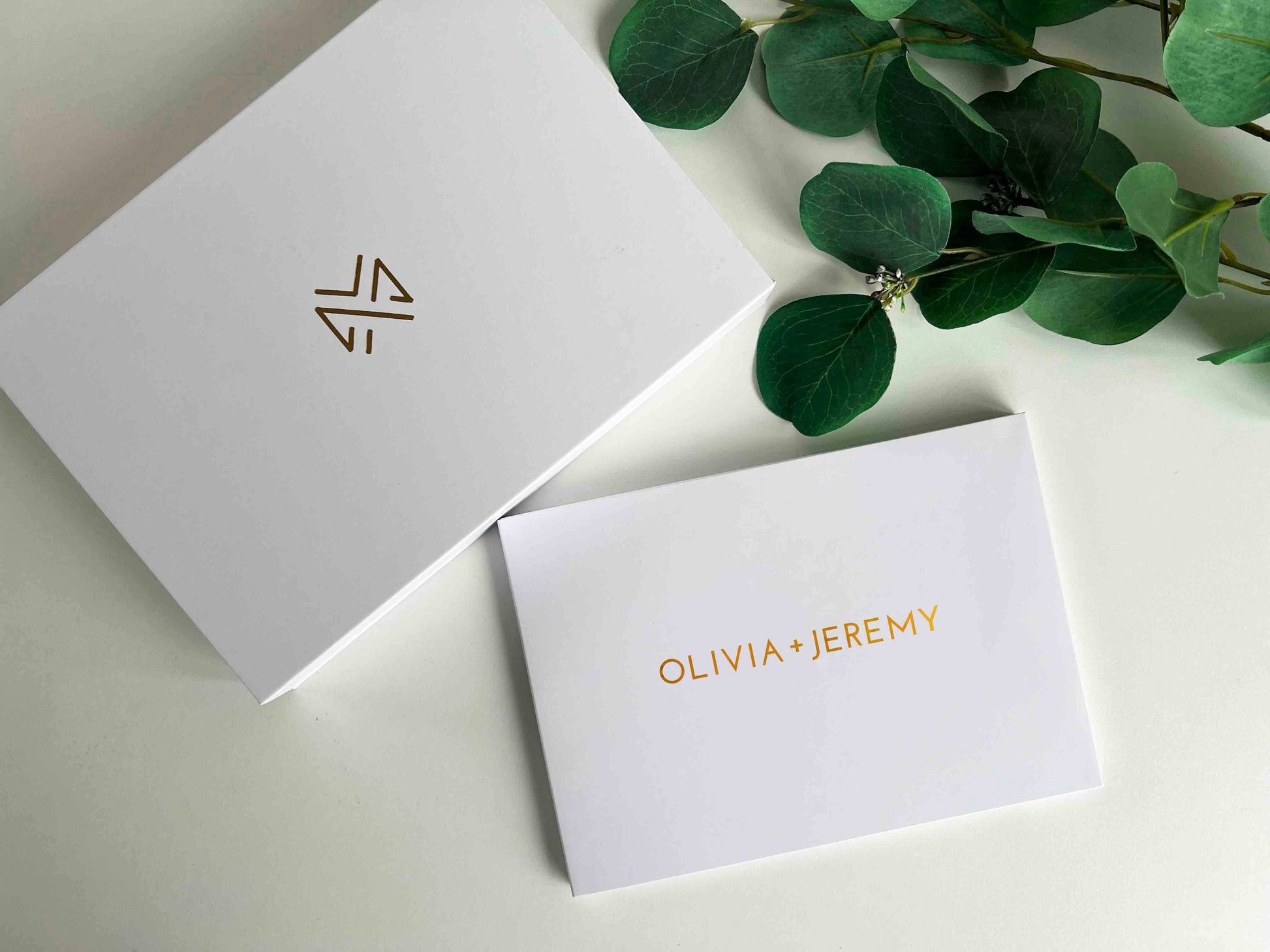 Memory Vault video book on the table with the box it comes in which has Memory Vault logo on it. This video book is personalised with custom name written on it in gold colour